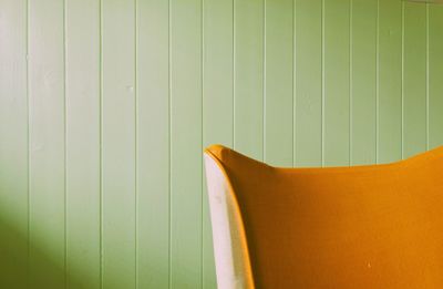 Orange sofa against wall