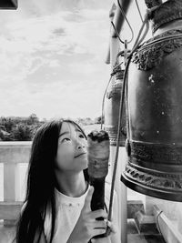 Portrait of young woman drinking water