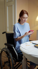 Full length of woman sitting at table