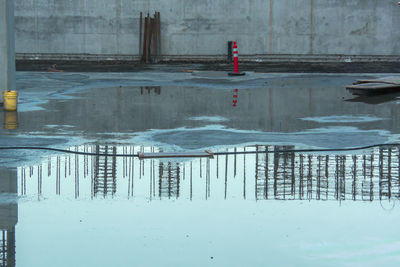 Reflection of frozen lake in swimming pool