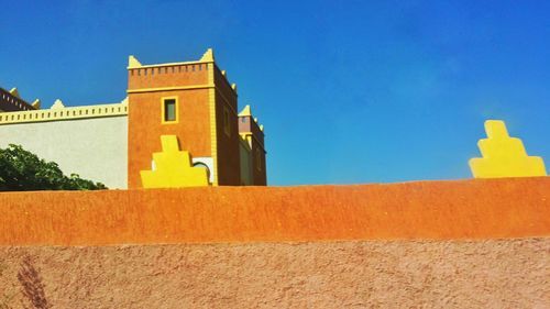 Low angle view of built structure against clear blue sky