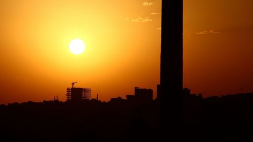 Silhouette of city during sunset