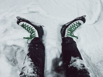 Low section of woman standing on snow