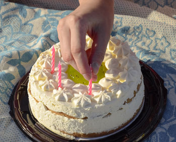 High angle view of hand holding cake