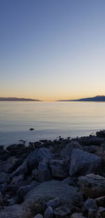 Scenic view of sea against clear sky during sunset