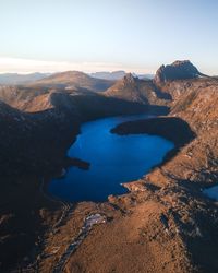 High angle view of lake and mountains against clear sky