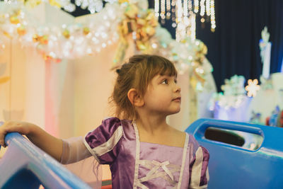 Girl against illuminated decorations at night