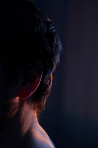 Close-up of woman head against black background