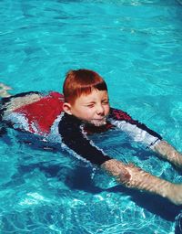 High angle view of boy swimming in pool