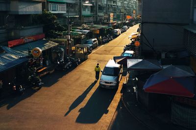 High angle view of man walking by car on street