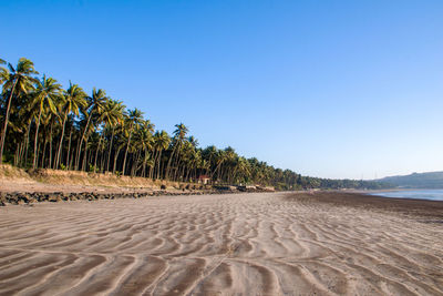 Scenic view of beach against clear blue sky