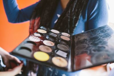 Midsection of woman holding palette