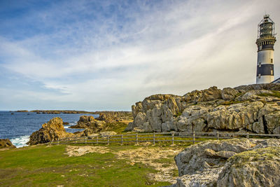 Scenic view of beach by sea against sky