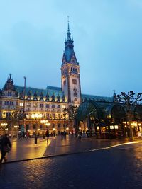 Illuminated buildings in city at dusk