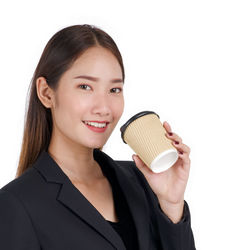Portrait of a smiling young woman over white background