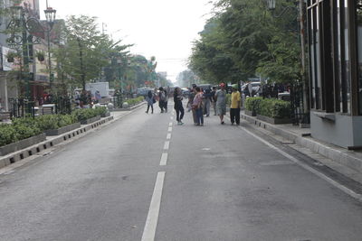 People walking on road in city