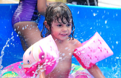 Shirtless girl enjoying in wading pool