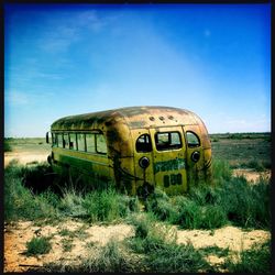 Grassy field against clear sky