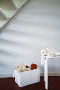 Stuffed toys in laundry basket and table at home
