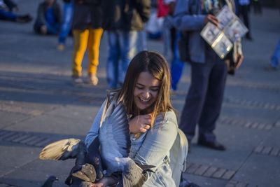 Woman with pigeons on street