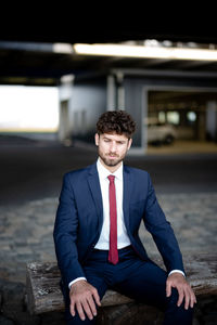 Portrait of young man sitting outdoors