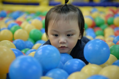 Close-up of baby playing in ball pool