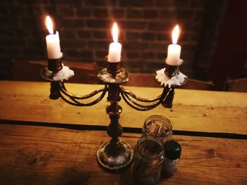 Close-up of illuminated candles on table