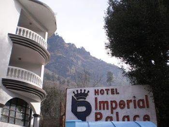 Information sign on mountain against sky