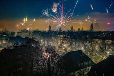 Firework display over city at night