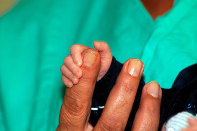 Close-up of hand holding hands