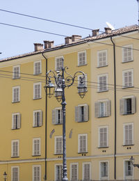 Low angle view of yellow building against sky