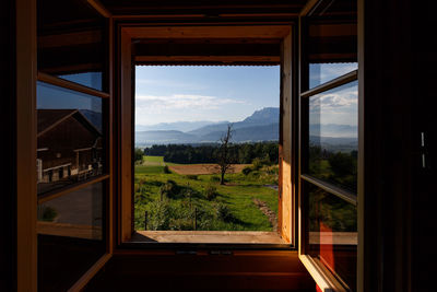 Scenic view of landscape seen through window