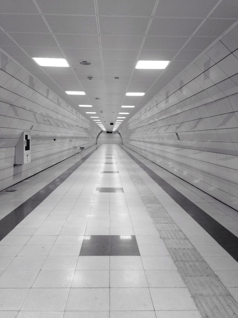 indoors, ceiling, transportation, architecture, the way forward, built structure, diminishing perspective, tiled floor, modern, railroad station, subway station, illuminated, vanishing point, airport, railroad station platform, flooring, travel, public transportation, empty, subway