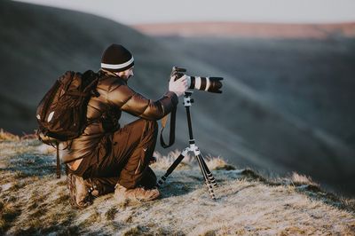 Man photographing with camera on land