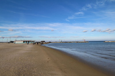 Scenic view of beach against blue sky