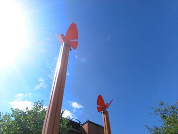 Low angle view of street light against blue sky