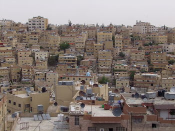 High angle view of houses in city against sky