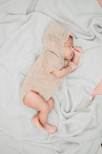 High angle view of baby sleeping on bed