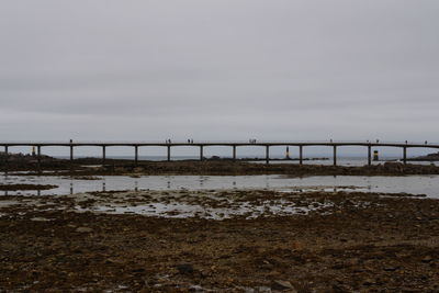 Bridge over sea against sky