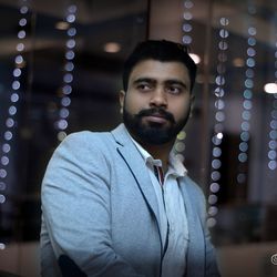 Portrait of young man standing at night