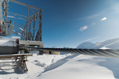 A cable car station high in the mountains under construction. snowy mountain landscape and