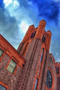 Low angle view of building against cloudy sky