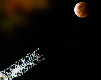 Low angle view of moon against clear sky at night