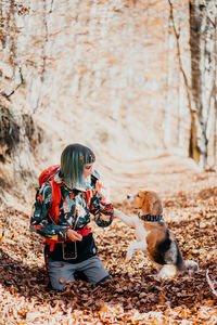 Rear view of man with dog on field