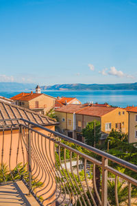 High angle view of townscape by sea against sky