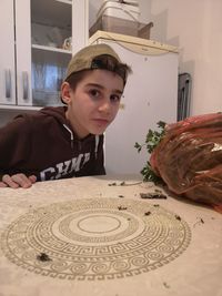 Portrait of boy on table at home