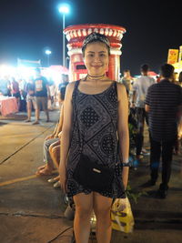 Portrait of woman standing at night