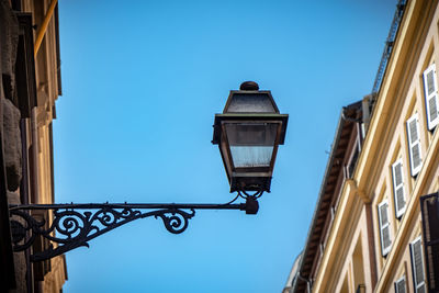 Low angle view of street light against building