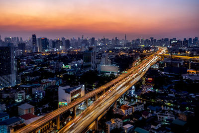 High angle view of illuminated street amidst buildings in city