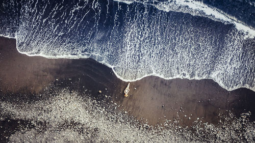 High angle view of woman lying at beach